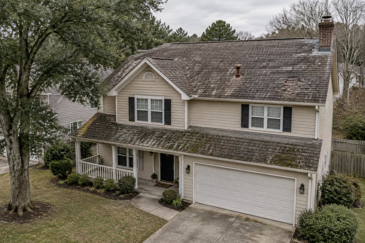 Home with an old, worn-out asphalt shingle roof